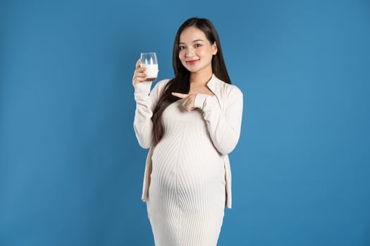 Portrait of pregnant asian woman, isolated on blue background photo