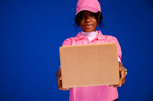 beautiful african delivery woman holding a package photo