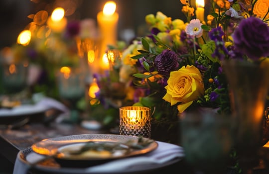 AI generated candle lights and table setting with yellow and purple flowers photo