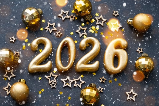 The golden figures 2026 made of candles on a black stone slate background are decorated with a festive decor of stars, sequins, fir branches, balls and garlands. Greeting card, happy New Year. photo