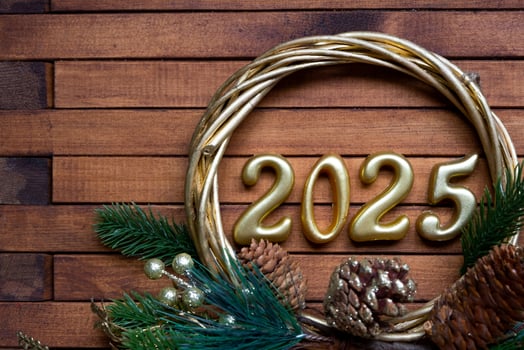 Happy New Year golden numbers 2025 on cozy festive brown wooden background with sequins, snow, lights of garlands. Greetings, postcard. Calendar, cover photo