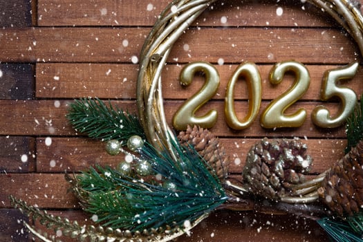 Happy New Year golden numbers 2025 on cozy festive brown wooden background with sequins, snow, lights of garlands. Greetings, postcard. Calendar, cover photo