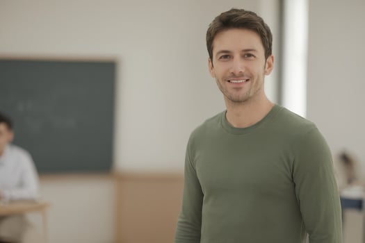 AI generated a handsome male teacher smiles in classroom with students photo