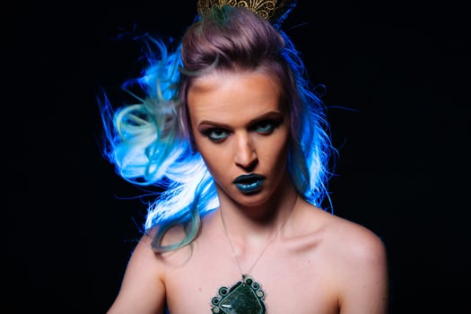 Blue-Haired Woman Wearing a Crown. A woman with blue hair and a crown on her head photo