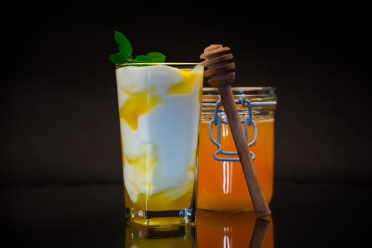 prepared homemade yogurt with natural honey in a glass photo