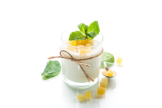 Sweet homemade yogurt with candied fruits in a glass photo