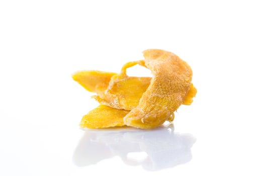 slices of sweet ripe dried mango on white background photo
