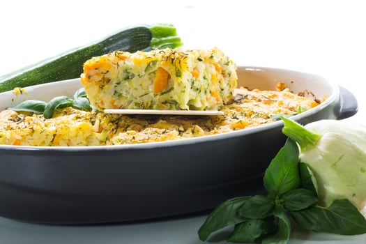 vegetable casserole of patissons, zucchini, carrots in a ceramic form . photo