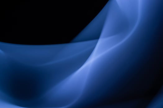 Blue abstract foggy background of waves and smooth lines on black. Design element. Copy Space. photo