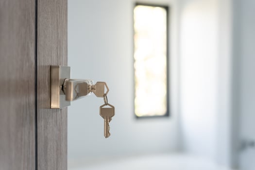 Landlord key for unlocking house is plugged into the door. Second hand house for rent and sale. Owner use hand unlock door mortgage for new home, buy, sell, renovate, investment, owner, estate photo