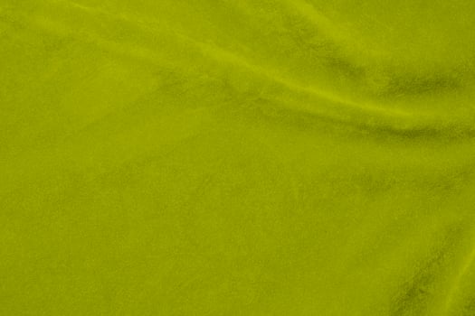lime color green velvet fabric texture used as background. Emerald color panne fabric background of soft and smooth textile material. crushed velvet .luxury emerald tone for silk. photo