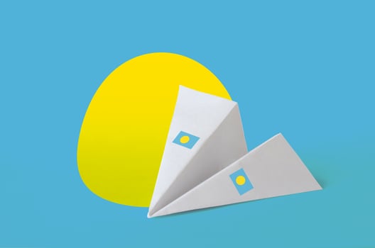 Palau flag depicted on paper origami airplane. Handmade arts concept photo