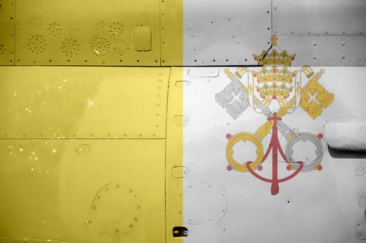 Vatican City State flag depicted on side part of military armored helicopter closeup. Army forces aircraft conceptual background photo