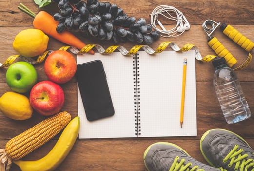 fitness concept with Exercise Equipment on wooden background. photo