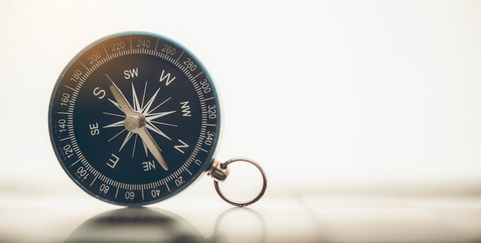 The blue compass is placed on background. photo