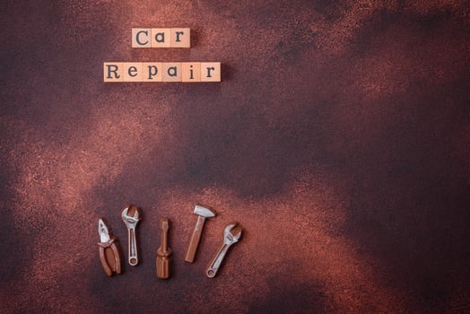 Tools and inscriptions symbolizing repairs or a garage and its attributes on a plain background photo