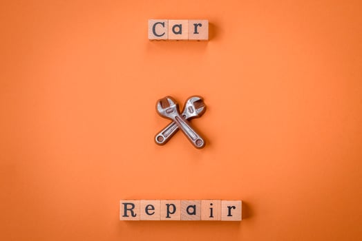 Tools and inscriptions symbolizing repairs or a garage and its attributes on a plain background photo