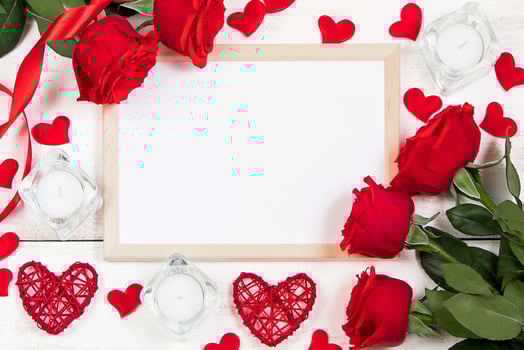 Red roses and hearts on a white wooden background. Valentine's day, place for text. photo