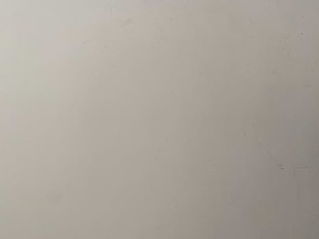 Old paint on a concrete wall, creating a textured and artistic white background. photo