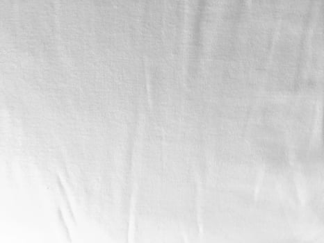A pristine white fabric background showcasing the luxurious texture of silk, creating an abstract and soft ambiance perfect for a high-end design. photo