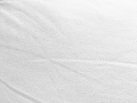 An exquisite cloth material in a bright, white hue, its smooth and silky surface evoking a sense of luxury and quality for a sophisticated background. photo