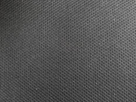 The play of light on the dark surface adds dimension to the abstract pattern, enhancing its visual appeal. photo