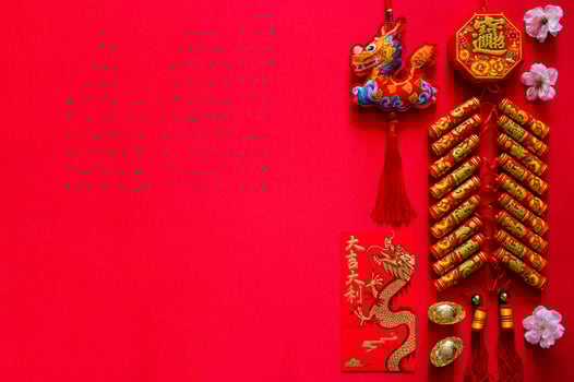 Firecrackers for Chinese new year word mean wealth, blessing with gold ingots word mean wealth, red envelope packet word mean good luck and good fortune and pendant dragon on red background. photo
