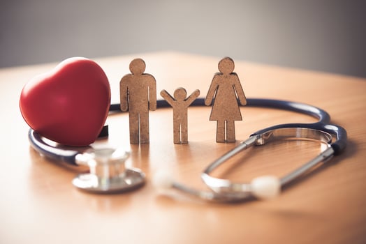 Medical Insurance Concept With Family  And Stethoscope On Wooden Desk photo