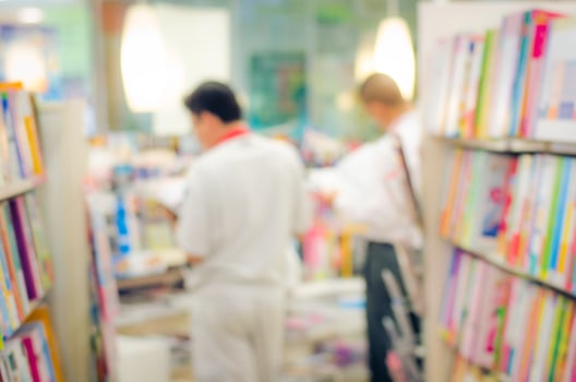 focused Blur image of a bookstore with customers reading and looking for books. Bookstore background. photo