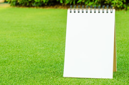 Notebook on fresh spring green grass photo