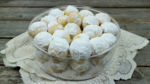 Kue putri salju or Snow White Cookies is a cookies that sprinkled with icing sugar photo