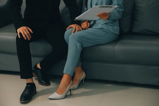 Sexsual harassment in workplace. Unhappy female employee looking at hand of boss touch at her shoulder and feeling disgusted. photo