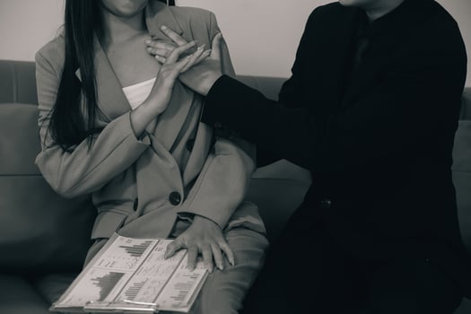 Sexsual harassment in workplace. Unhappy female employee looking at hand of boss touch at her shoulder and feeling disgusted. photo