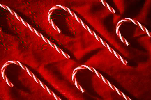 Christmas candy canes on burgundy velvet background. photo