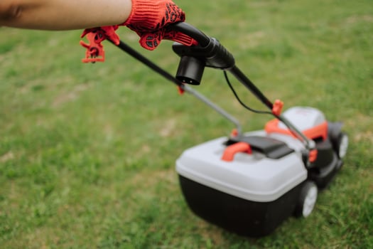 Lawn mover on green grass in modern garden. Machine for cutting lawns. Safety equipment with garden tools photo