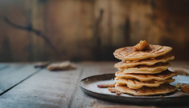 Copy Space image of Delicious viennese waffles with maple syrup drizzle and blackberry on dark brown wood background. photo