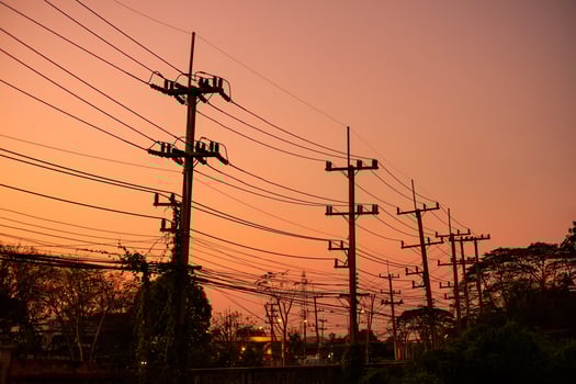 Utility pole with power line in the evening photo