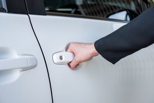 Formal hand on handle opening a car door photo