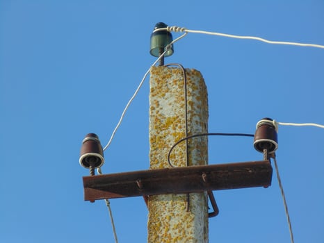 electric column. Electric column with wires during a decline against the clear blue sky. photo