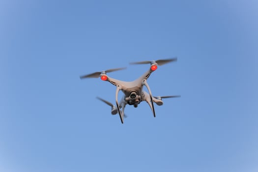The drone, hovering in the sky. Flight quadrocopters photo