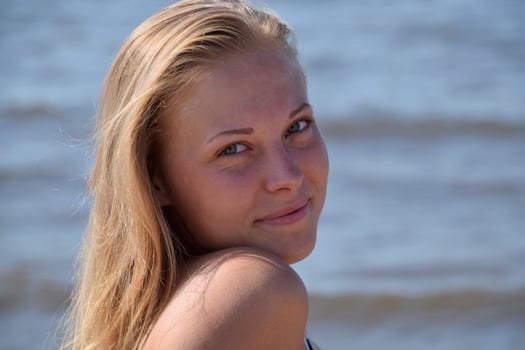 The girl blonde on a background of sea water. Beautiful young woman photo