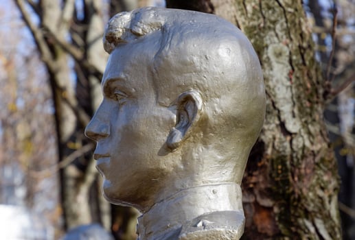 The face of the stone man. Concrete soldier bust covered with pa photo