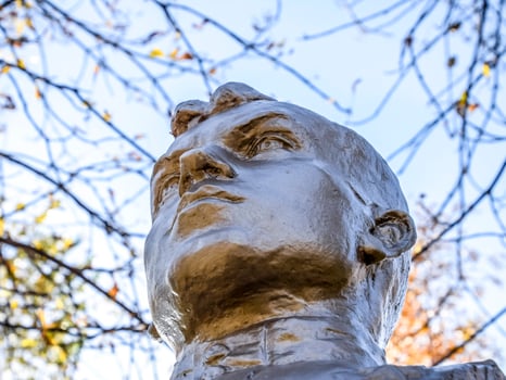 The face of the stone man. Concrete soldier bust covered with pa photo