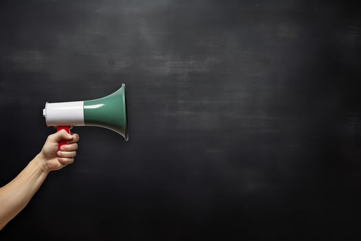 AI generated Hand holding megaphone over chalkboard background with copy space photo