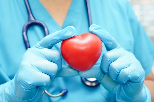 Asian woman doctor holding red heart for health in hospital. photo