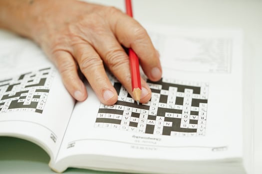 elderly woman playing sudoku puzzle game for treatment dementia prevention and Alzheimer disease. photo