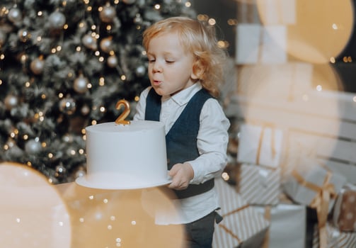 Cheerful and happy family with Christmas gifts celebrating birthday for two years. Children are having fun. Loving family with gifts in the room. photo