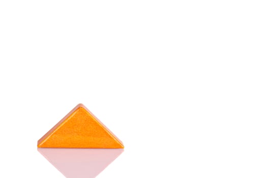 Wooden triangle orange colors on a white background photo