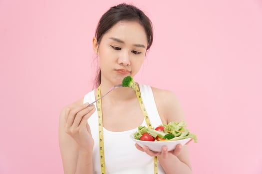 slim body asian women very bored diet food, dieting female choose low calories food for diet. Good healthy food. weight lose, balance, control, reduce fat, routines, exercise, body shape photo