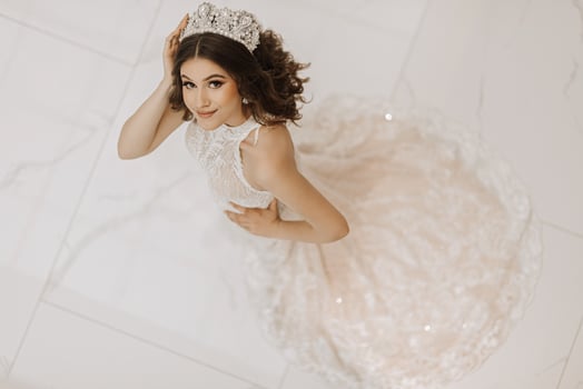 Top view, beautiful bride, with a white wedding dress and a luxurious crown on her head. Horizontal photo